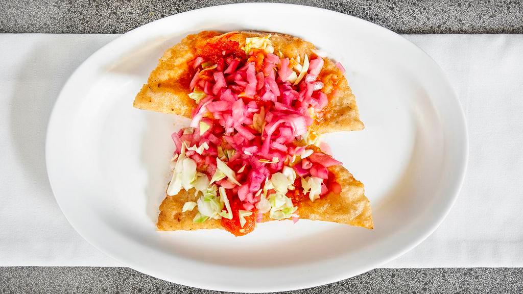Empanada · Fried corn Masa filled with mozzarella cheese, ground pork, or Chicken. Topped with cabbage, tomato sauce, and red onions.