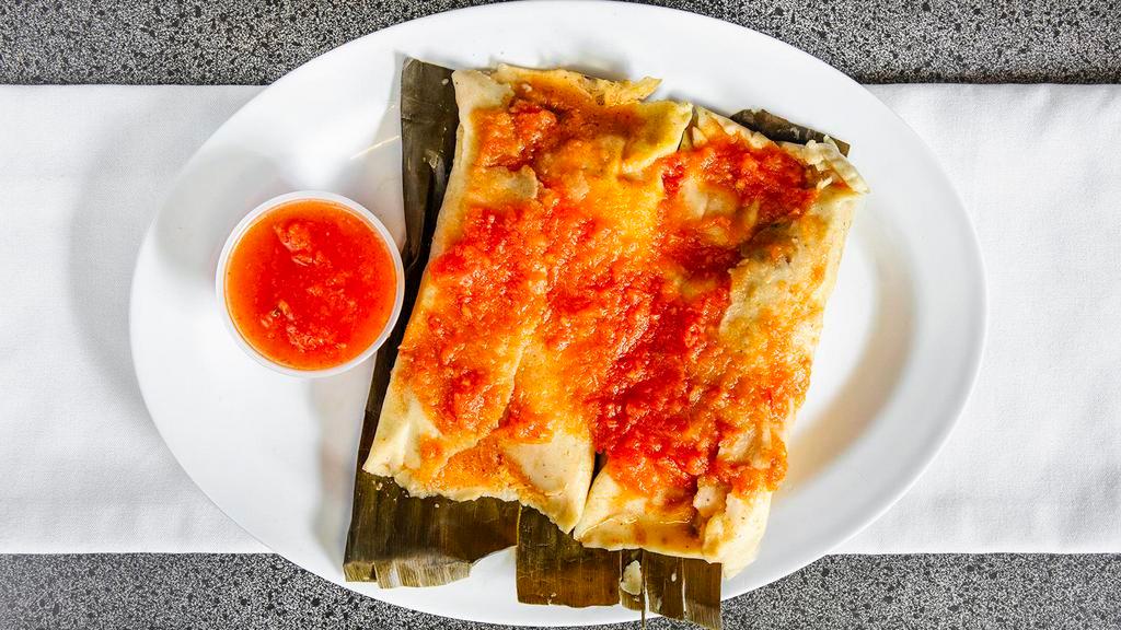 Yucatecan Tamales · Steamed corn dough. Filled with chicken and tomato sauce.