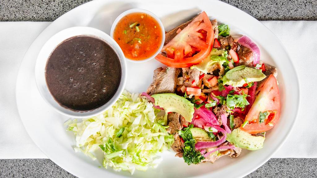Poc-Chuc · Grilled pork marinated with beer, onion, cilantro, and, black pepper. Served with fried black beans, cabbage, tomato salsa.6 freshly handmade tortillas included.