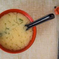Miso Soup · Japanese soybean paste soup with green onions and organic tofu.