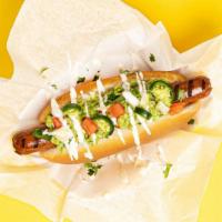 Chihuahua Dog · Hot dog topped with guacamole, sliced jalapenos, tomatoes, and a sour cream drizzle, served ...