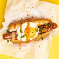 Morning Dog · Bacon wrapped dog topped with a fried egg, sliced scallions, and drizzled with sriracha, ser...
