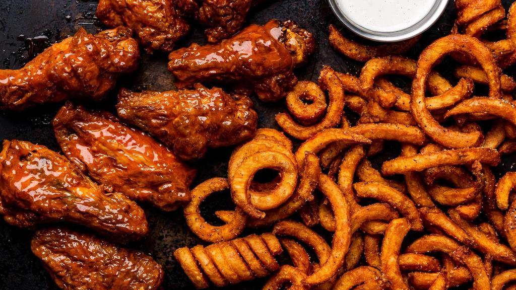 8 Smoked Bone-In Wings · 8 bone-in wings smoked in-house over pecan wood then tossed with your choice of flavor. Served with curly fries  & a side of ranch.