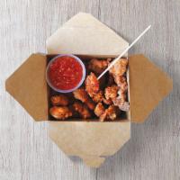 Popcorn Chicken · Fried chicken bites served with sweet and sour sauce.