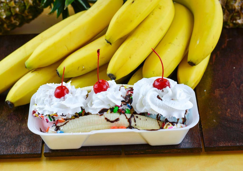 Banana Split · A banana split in half covered with three scoops of ice cream. Topped with fudge drizzle, whipped cream, cherries, and peanuts.
