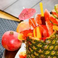 Pina Loca · diced fruit in a decorative pineapple shell, topped with salt lime, and chamoy