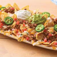 Neighborhood Nachos Beef · Freshly made white corn tortilla chips are topped with taco-seasoned ground beef, queso blan...
