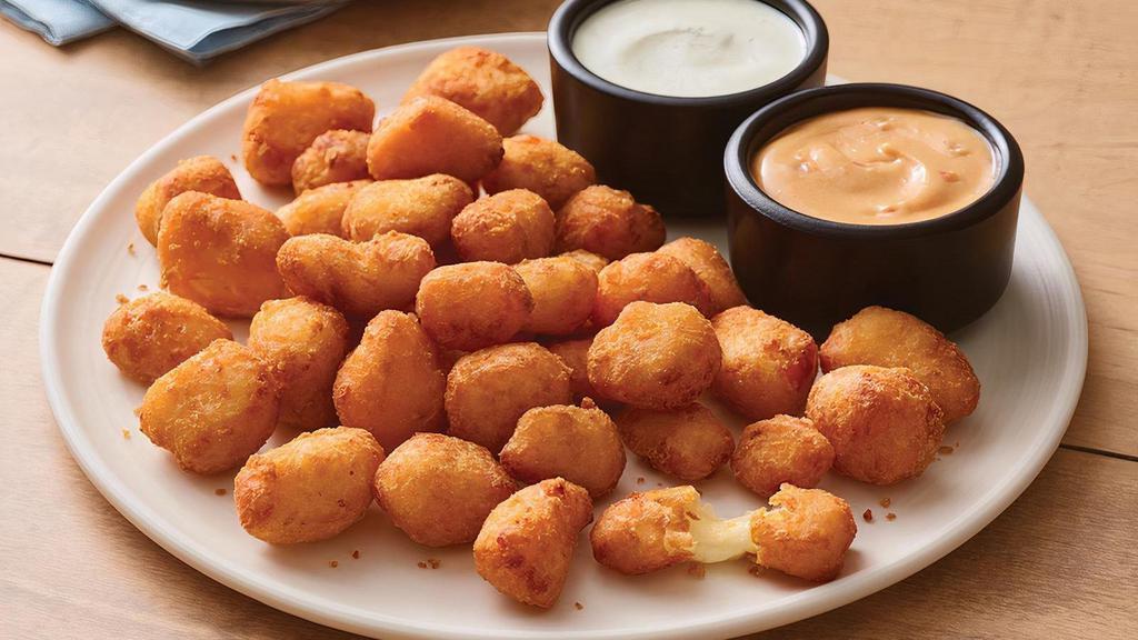 Crispy Cheese Bites · Golden, crispy and melty cheese bites, these favorites are served with house-made buttermilk ranch and firecracker mayo for dipping.