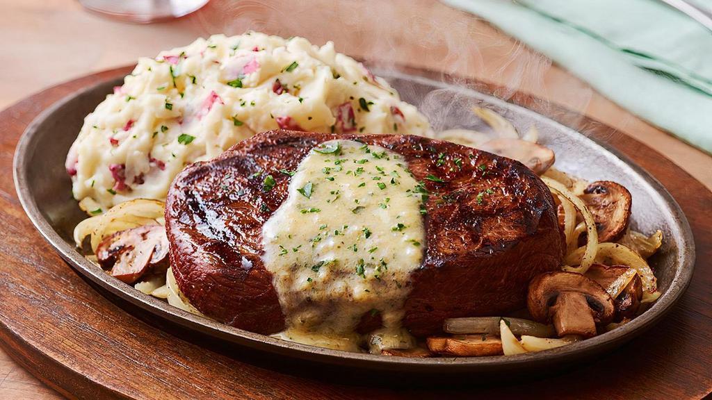Bourbon Street Steak* · Big flavor from New Orleans. A grilled 8 oz. USDA Select Top Sirloin* is jazzed up with Cajun spices and garlic butter served sizzling on a cast iron platter with sautéed mushrooms and onions. Served with garlic mashed potatoes.