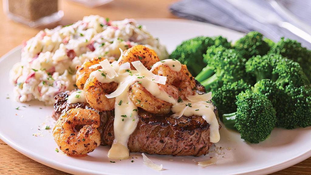 Shrimp 'N Parmesan Sirloin* · A popular take on surf 'n turf, this dish starts with a tender grilled 8 oz. USDA Select top sirloin* and is topped with sautéed blackened shrimp and our creamy lemon butter Parmesan sauce. Served with garlic mashed potatoes and steamed broccoli.
