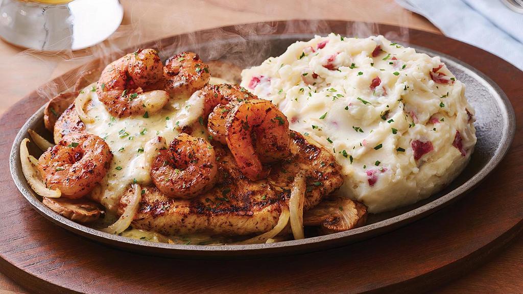 Bourbon Street Chicken & Shrimp · Let the good times roll with Cajun-seasoned chicken and blackened shrimp in buttery garlic and parsley, served sizzling on a cast iron platter with sautéed mushrooms and onions. Served with garlic mashed potatoes.