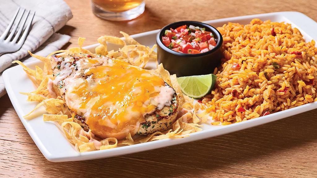 Fiesta Lime Chicken® · A celebration of flavor, this dish delivers on every level. Grilled chicken glazed with zesty lime sauce and drizzled with tangy Mexi-ranch is smothered with a rich blend of Cheddar cheeses on a bed of crispy tortilla strips. Served with Spanish rice and house-made pico de gallo.  (Due to supply constraints, salsa may be substituted for pico. Ask your local restaurant for details.)