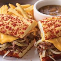 The Prime Rib Dipper · Thinly sliced prime rib topped with grilled onions and melted American cheese. Served on a t...