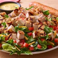 Grilled Chicken Tender Salad · A hearty salad with juicy grilled chicken on a bed of fresh greens topped with a blend of Ch...