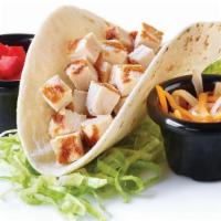 Kid'S Chicken Taco · A soft flour tortilla shell filled with chopped chicken and Cheddar cheese. Served with lett...