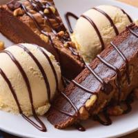 Blue Ribbon Brownie · Warm dark chocolate brownie with nuts. Served with vanilla ice cream and drizzled with hot f...