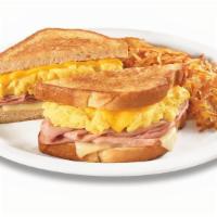 Moons Over My Hammy® · Ham and scrambled egg sandwich with Swiss & American cheeses on grilled sourdough. Served wi...