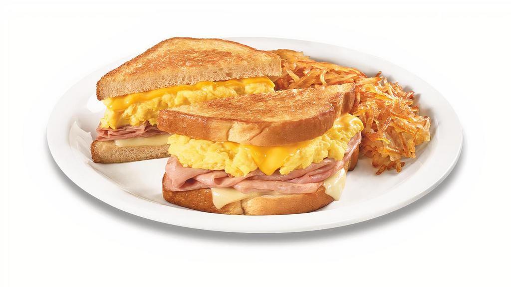 Moons Over My Hammy® · Ham and scrambled egg sandwich with Swiss & American cheeses on grilled sourdough. Served with hash browns..