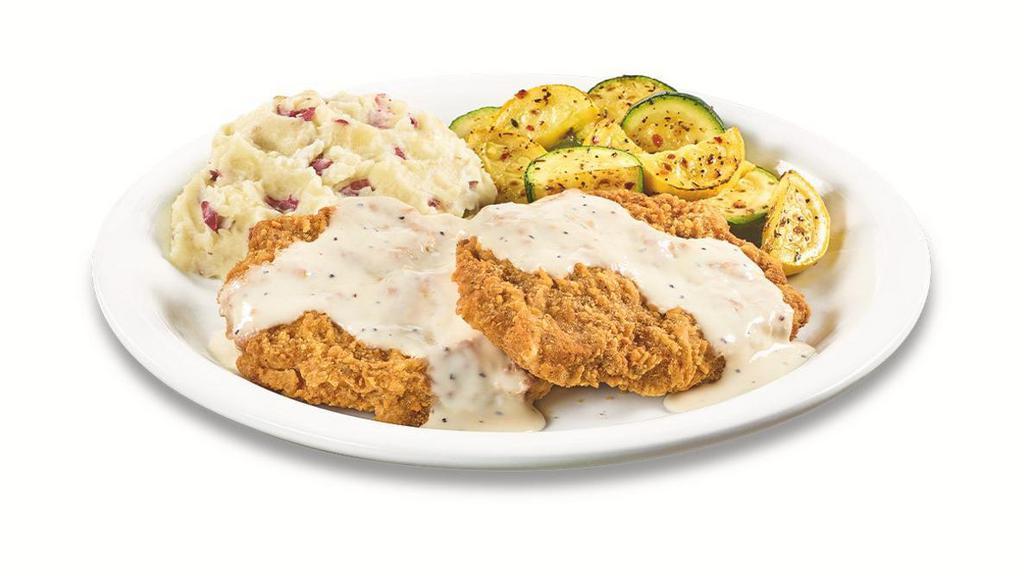 Country-Fried Steak Dinner · Two chopped beef steaks smothered in country gravy. Served with two sides and dinner bread.