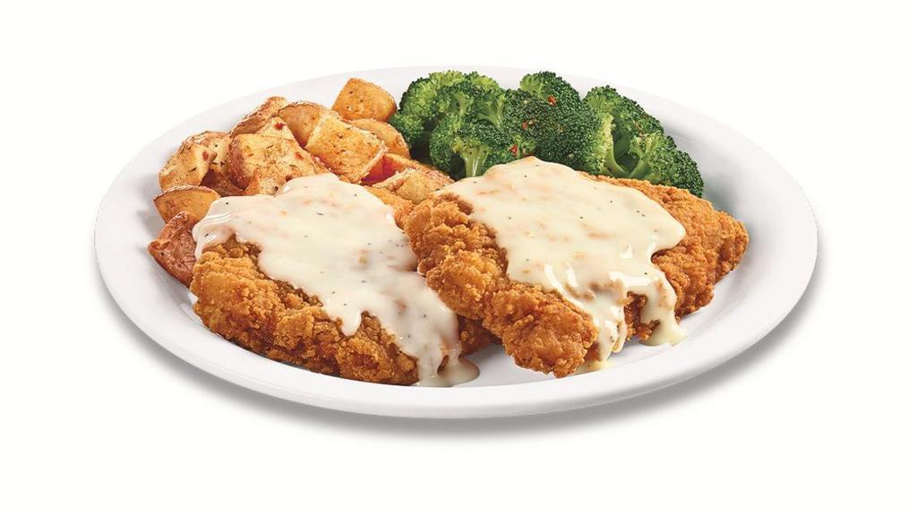 Plate Lickin' Chicken Fried Chicken · Golden-fried boneless chicken breasts smothered in country gravy. Served with two sides and dinner bread.