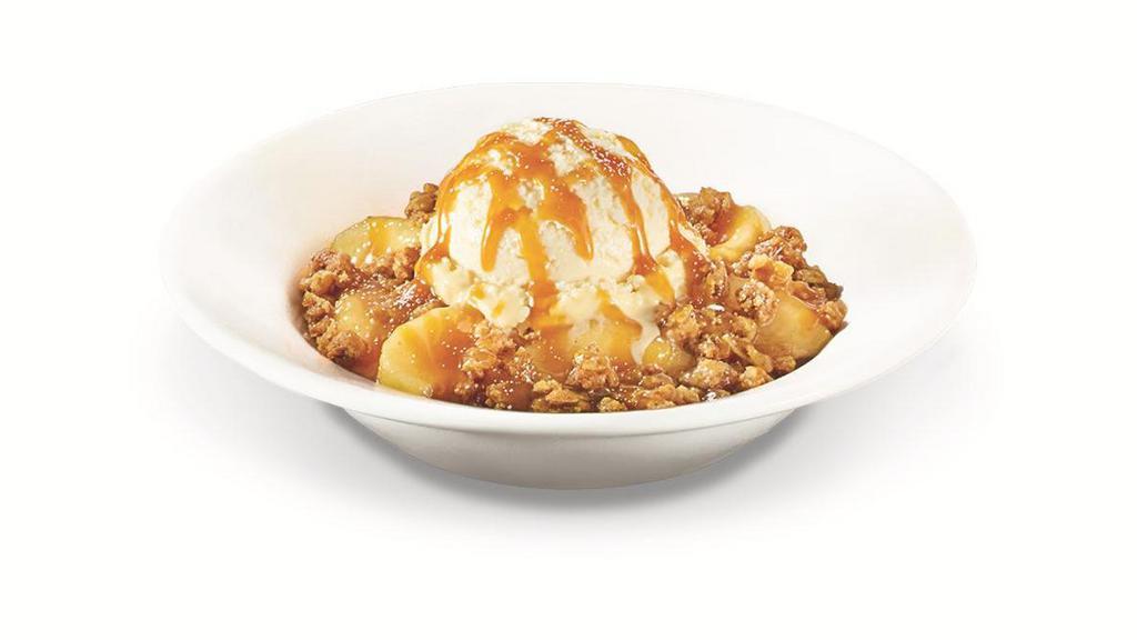 Caramel Apple Pie Crisp · Warm apple pie crisp topped with premium vanilla ice cream, salted caramel and powdered sugar..