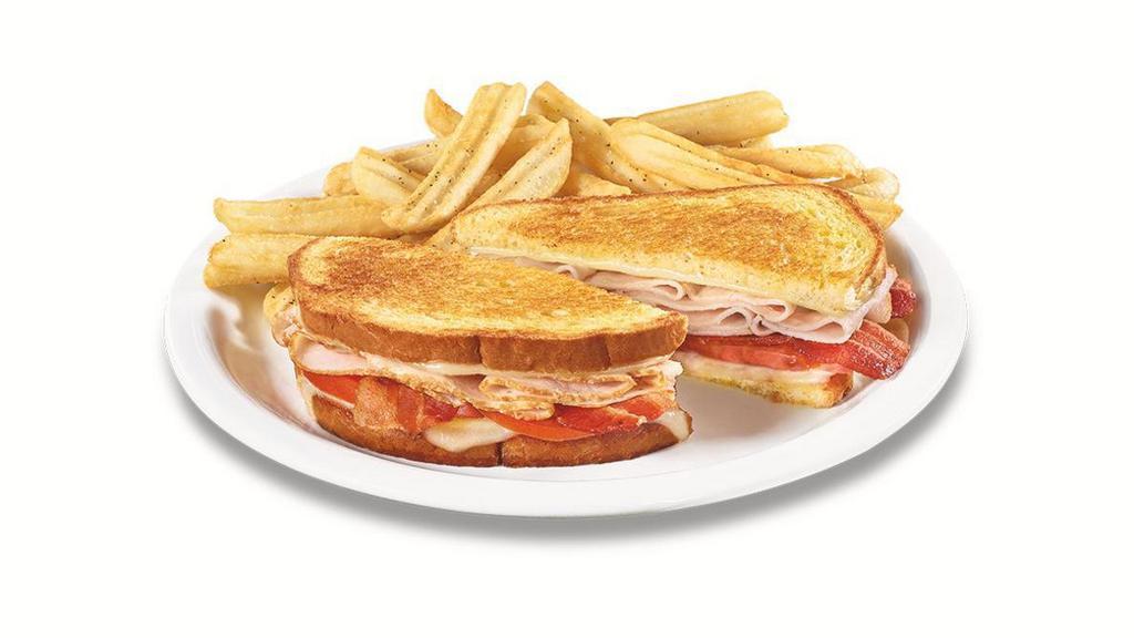 The Super Bird® · Turkey breast with Swiss cheese, bacon and tomato on grilled sourdough. Served with wavy-cut fries.