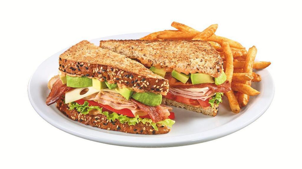 Cali Club Sandwich · Turkey breast, ham, bacon, Swiss cheese, fresh avocado, sun-dried tomato mayo, lettuce and tomato on toasted 7-grain bread. Served with wavy-cut fries.   .