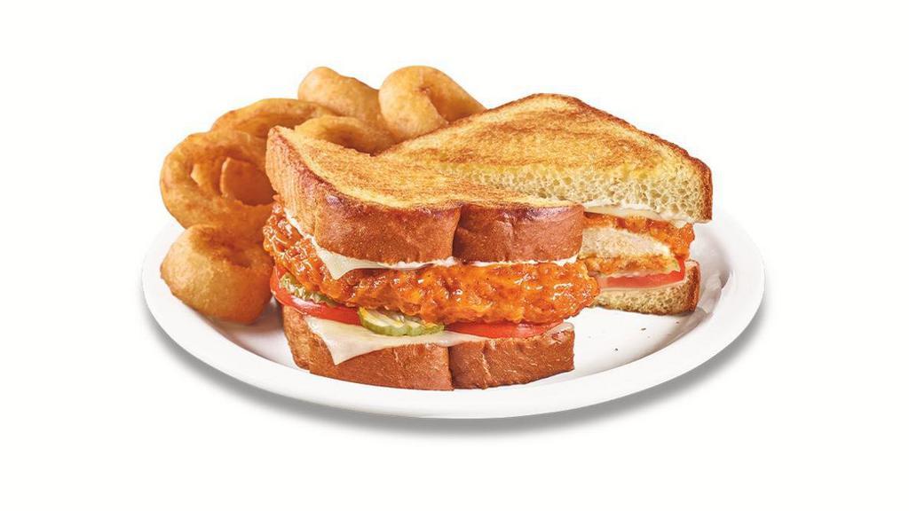 Nashville Hot Chicken Melt · A golden-fried chicken breast tossed in Nashville Hot sauce with Swiss cheese, tomato, pickles and mayo on grilled Texas toast.  Served with wavy-cut fries.