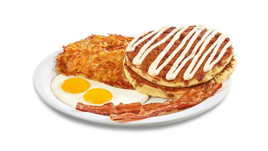 Cinnamon Roll Pancake Breakfast · Buttermilk pancakes cooked with cinnamon crumb topping and topped with cream cheese icing. Served with eggs,* hash browns, plus bacon strips or sausage links.