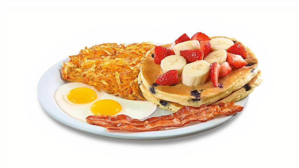Double Berry Pancake Breakfast · Buttermilk pancakes cooked with blueberries and topped with fresh seasonal berries and bananas. Served with eggs,* hash browns, plus bacon strips or sausage links.
