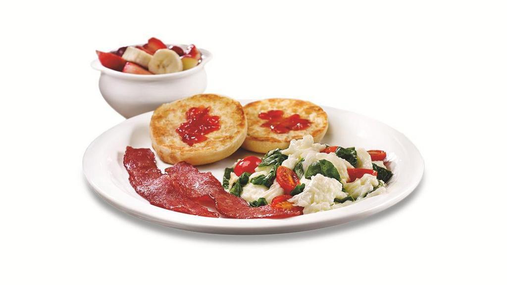 Fit Slam® · Egg whites scrambled together with fresh spinach and grape tomatoes, plus turkey bacon strips, an English muffin and seasonal fruit.  .