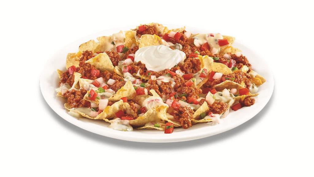 Zesty Nachos · Tortilla chips freshly cooked and topped with Pepper Jack queso, cheddar cheese, seasoned nacho meat, fresh pico de gallo and sour cream on the side to keep chips crispy until you’re ready to assemble & devour!  .