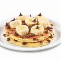 Stack Of Choconana Pancakes  · Ghirardelli® chocolate chips cooked inside buttermilk pancakes and topped with bananas and m...
