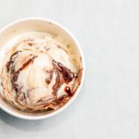 Tin Roof Sundae · Vanilla based ice cream with chocolate-covered almonds and chocolate fudge swirled in. Our n...