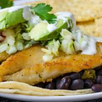 Fish Taco · Pan-seared fish with chopped cabbage, avocado, black beans, cilantro rice and Mexican cream ...