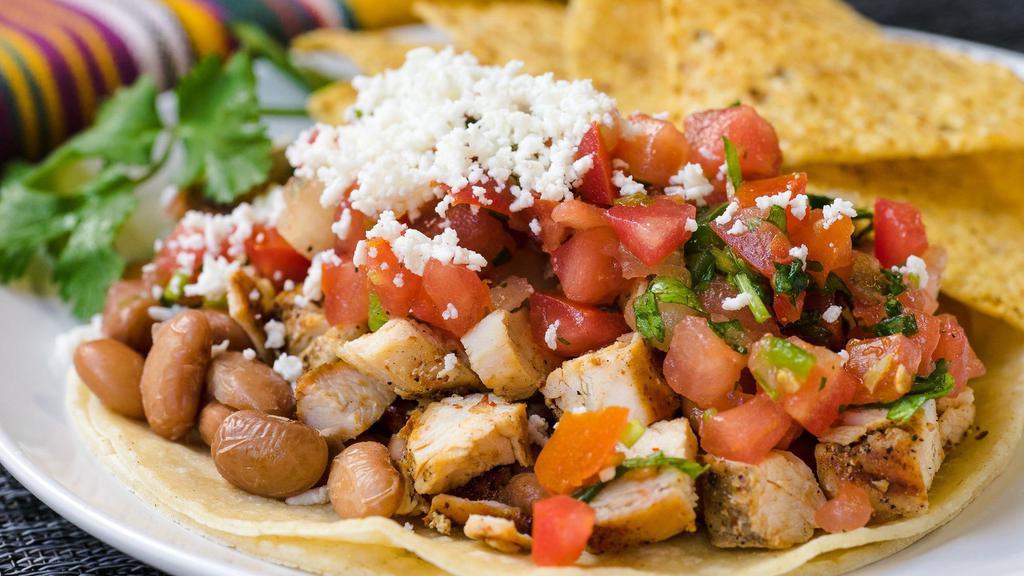 Soft Tacos · Large soft corn tortilla piled with beans, salsa fresca, fresh cheese, and your choice of filling. Served with chips.