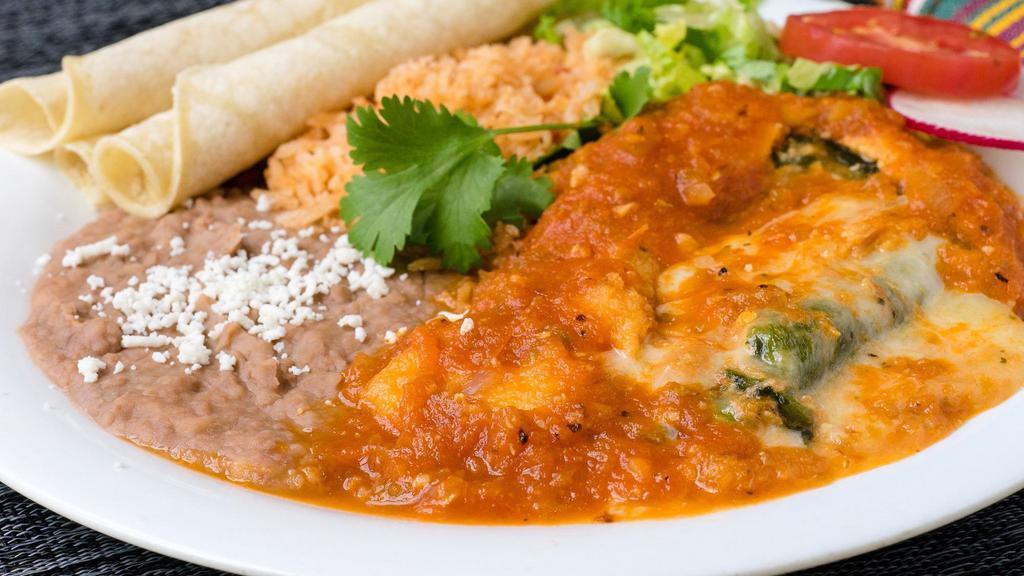 Chile Relleno · Roasted poblano Chile filled with cheese, battered and fried. Served with ranchera sauce, rice, beans, and warm tortillas.