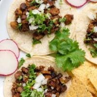 Street Tacos · Three soft corn tortillas topped with beef, chicken or pork al pastor, cilantro, onions, rad...