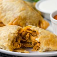 Empanadillas · Flaky turnovers filled with chicken and red mole sauce.