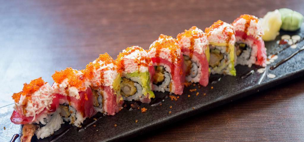 75. Red Dragon · Shrimp tempura, cucumber, tuna, avocado topped with crab meat & tobiko.
