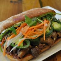 F2. BBQ Beef Sandwich · All include pickled carrots & Dalkon, cucumber, cilantro, jalapenos and mayo on a fresh bagu...