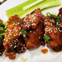ASIAN WINGS · With sweet and spicy glaze, green onion, sesame seeds
