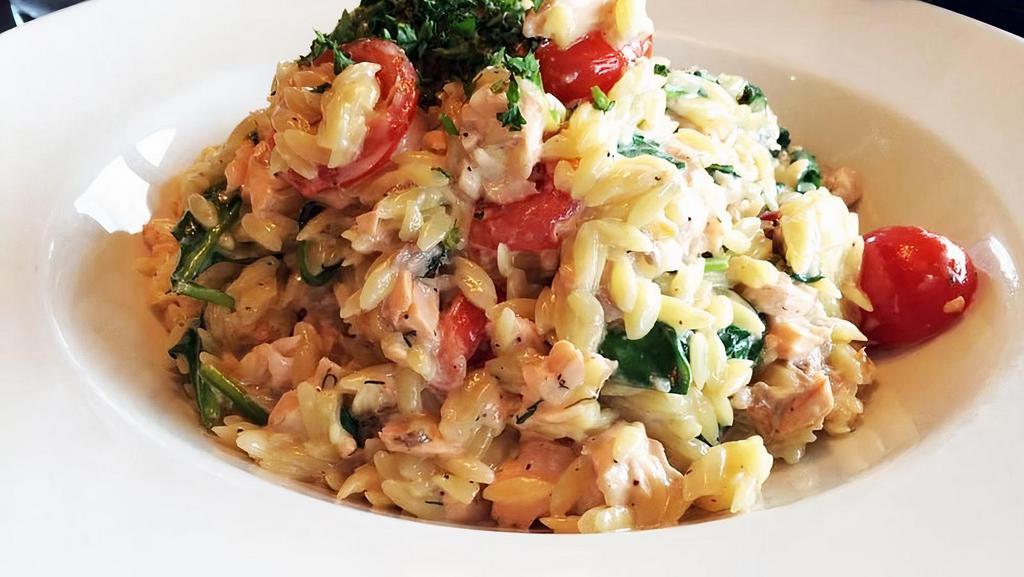 ORZO SALMON · Grilled Salmon tossed with orzo pasta, cherry tomatoes, baby spinach, fresh dill, lemon, white wine, cream, butter, garlic