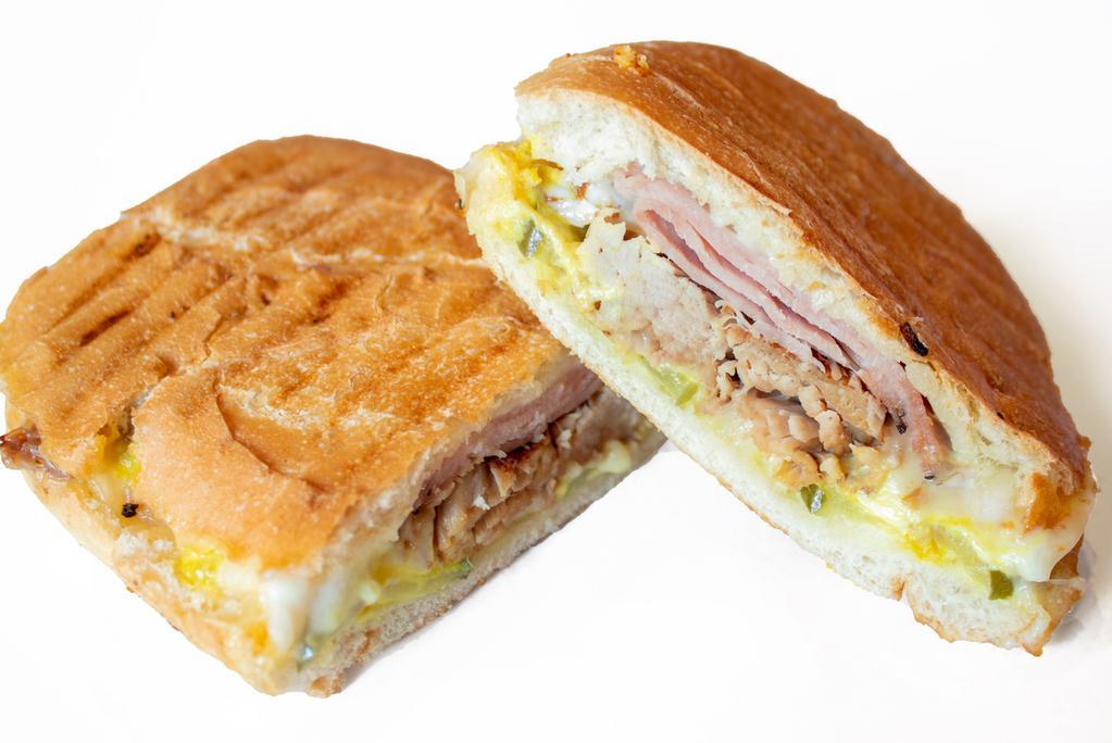 Cubano · Hot ham, roasted pork and Swiss with mayo, yellow mustard, and pickles on a soft french roll, panini grilled.
