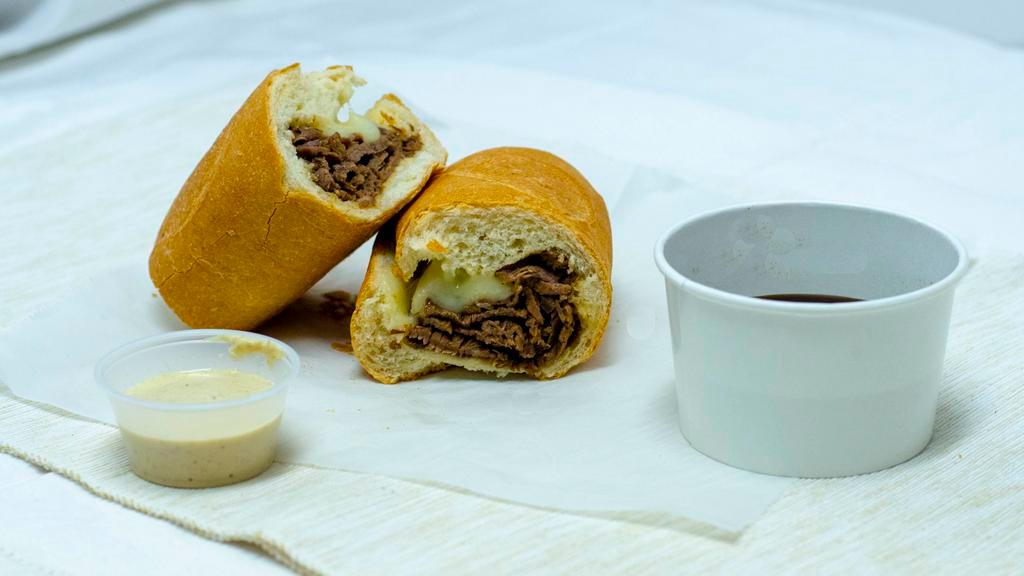 Tri Tip French Dip · Our house-made Tri-Tip & Provolone on Soft French Roll, Oven Baked w/ Au Jus & Creamy Horseradish on the side