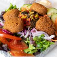 Falafel Salad · With hummus and olive tapenade, tomatoes, red onions, carrots and cucumbers on mixed greens.