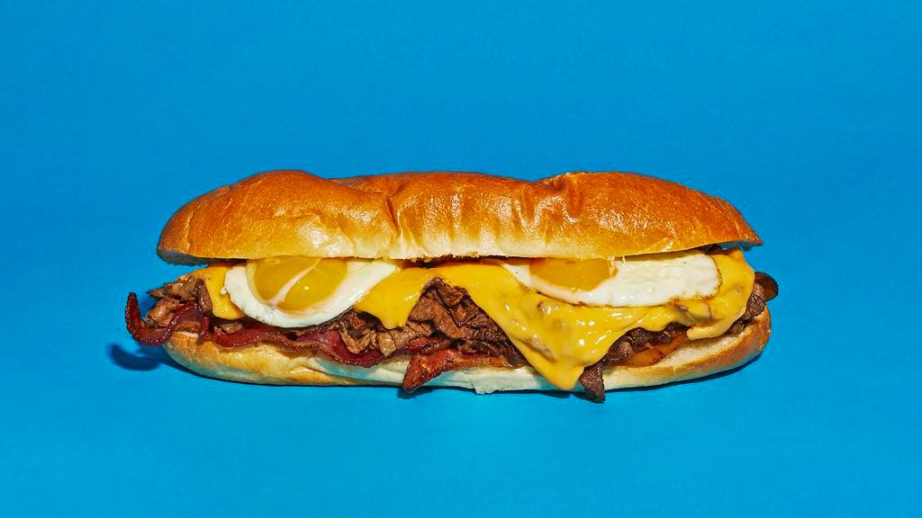 Breakfast Cheesesteak · Sliced steak with melted cheddar, crispy bacon, and a fried egg on a hoagie roll.