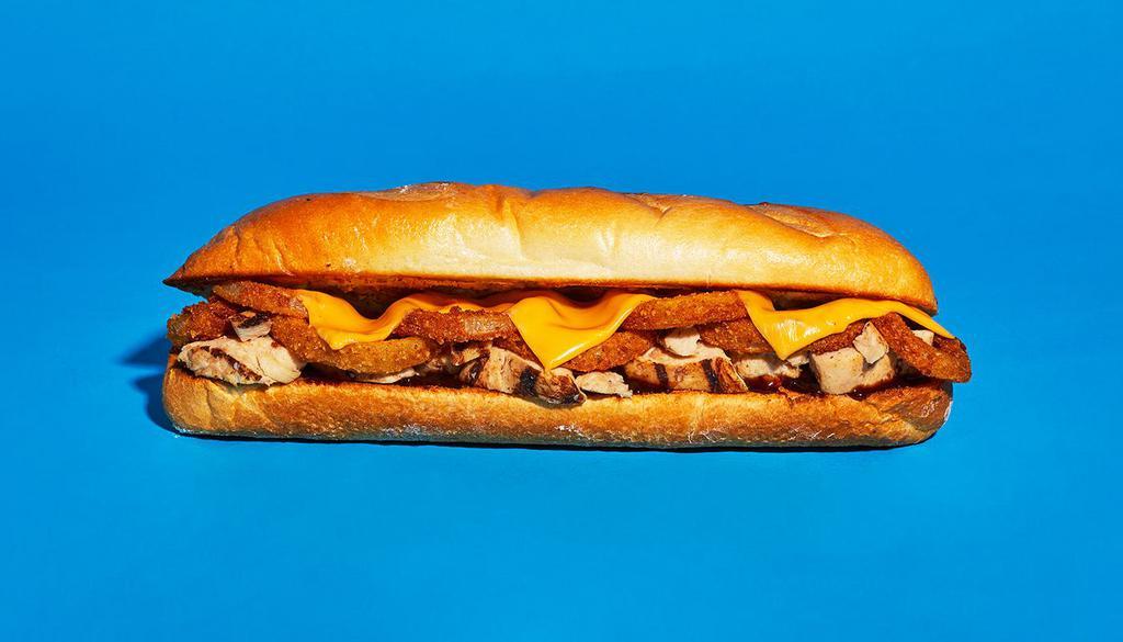 Bbq Chicken Cheesesteak · Sliced chicken with melted cheddar, fried onion rings, and tangy BBQ sauce on a hoagie roll.