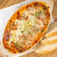 Lasagna · Baked. Noodles with ground beef, sausage, ricotta cheese, and tomato sauce topped with mozza...
