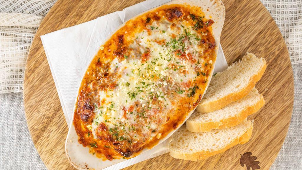 Lasagna · Baked. Noodles with ground beef, sausage, ricotta cheese, and tomato sauce topped with mozzarella cheese.